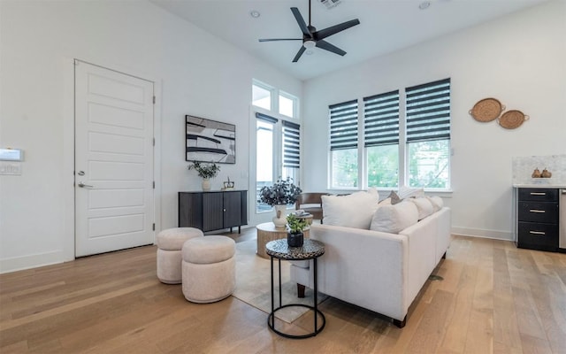 6221 Florencia Ln, Austin, TX 78724 - living area with healthy amount of natural light, light wood-style flooring, and a ceiling fan