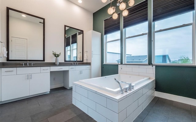 6221 Florencia Ln, Austin, TX 78724 - full bathroom with double vanity, a bath, and tile patterned floors