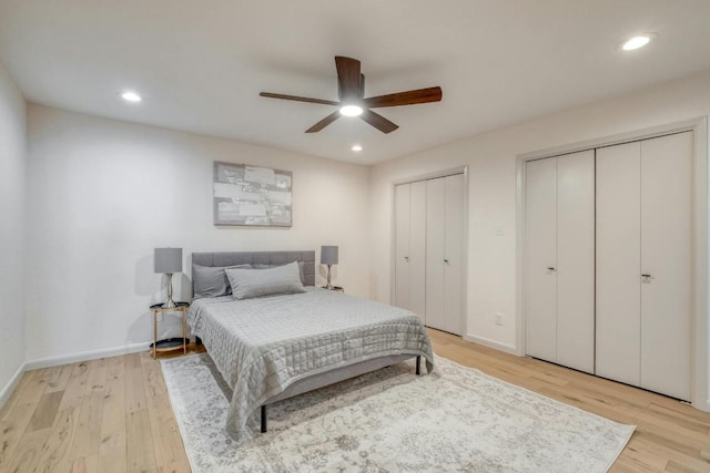 313 Lucy Ln, Horseshoe Bay, TX 78657 - bedroom with two closets, light wood-style flooring, baseboards, recessed lighting, and a ceiling fan