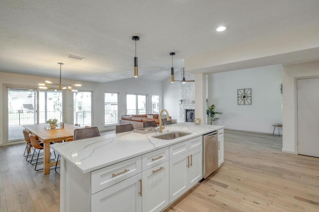 313 Lucy Ln, Horseshoe Bay, TX 78657 - kitchen featuring a sink, stainless steel dishwasher, a chandelier, light wood finished floors, and open floor plan