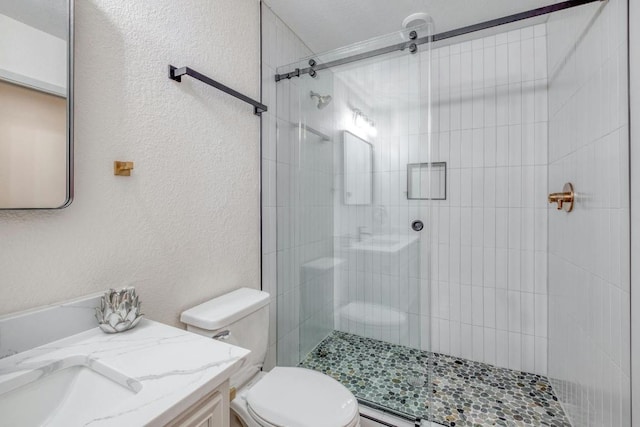 313 Lucy Ln, Horseshoe Bay, TX 78657 - full bath featuring toilet, tiled shower, vanity, a textured wall, and a baseboard radiator