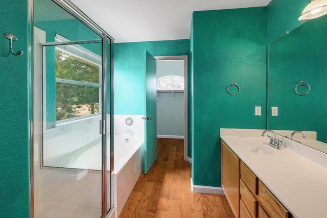 4142 Rockwood Dr, Lago Vista, TX 78645 - full bathroom featuring vanity, wood finished floors, a bath, and healthy amount of natural light