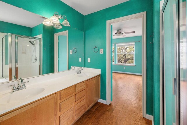 4142 Rockwood Dr, Lago Vista, TX 78645 - full bathroom with wood finished floors, a stall shower, and double vanity