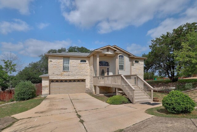 4142 Rockwood Dr, Lago Vista, TX 78645 - view of front of house with stone siding, driveway, and a garage