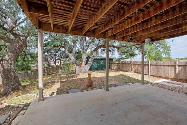 4142 Rockwood Dr, Lago Vista, TX 78645 - fenced backyard featuring a patio and an outbuilding