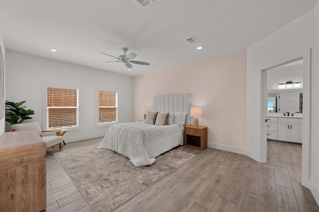 509 Flamingo Blvd, Lakeway, TX 78734 - bedroom with light wood-type flooring, recessed lighting, ceiling fan, and ensuite bath