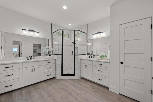 509 Flamingo Blvd, Lakeway, TX 78734 - full bath with a shower stall, two vanities, wood finished floors, and recessed lighting