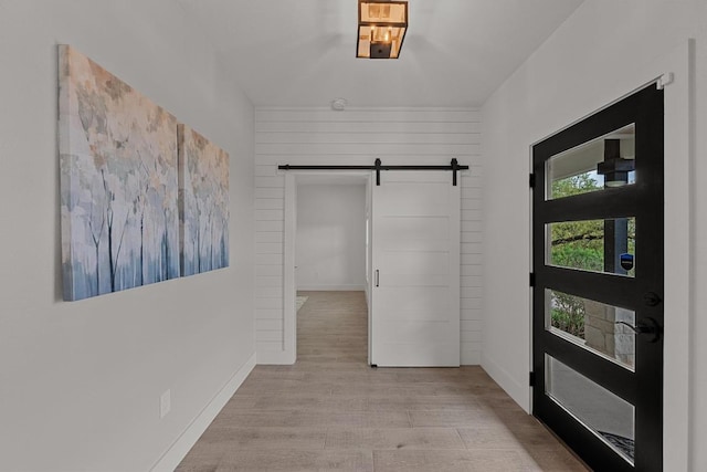 509 Flamingo Blvd, Lakeway, TX 78734 - foyer featuring a barn door, light wood-style floors, and baseboards