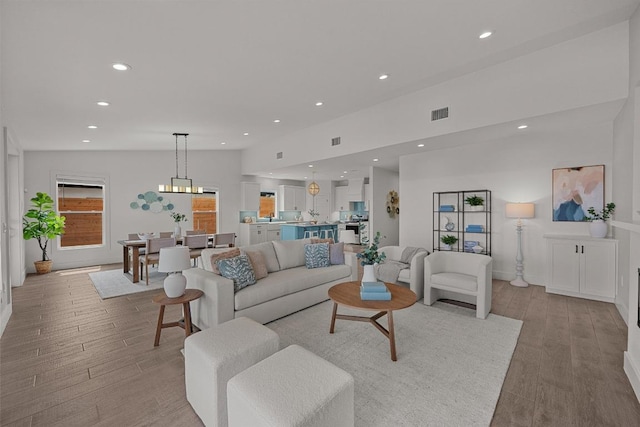 509 Flamingo Blvd, Lakeway, TX 78734 - living room with recessed lighting, light wood finished floors, and a chandelier