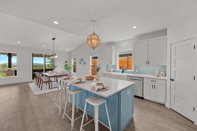 509 Flamingo Blvd, Lakeway, TX 78734 - kitchen with dishwasher, light wood finished floors, light countertops, white cabinetry, and recessed lighting