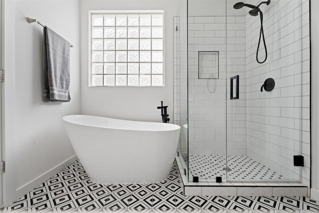 102 Hurst Creek Rd, Lakeway, TX 78734 - full bathroom with baseboards, a stall shower, and a freestanding tub