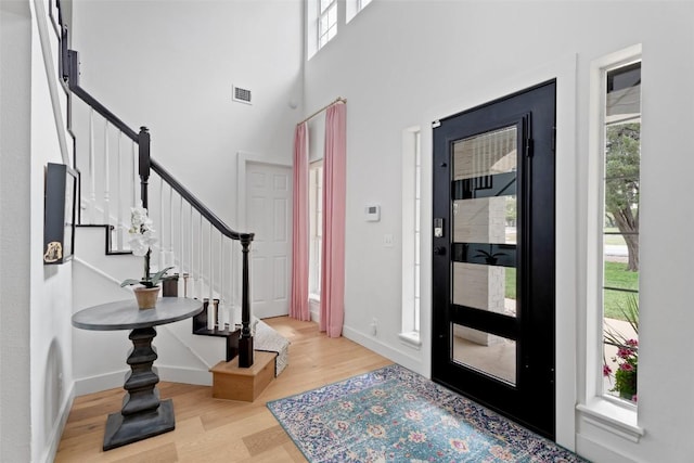 102 Hurst Creek Rd, Lakeway, TX 78734 - entryway featuring wood finished floors, stairs, healthy amount of natural light, baseboards, and a towering ceiling