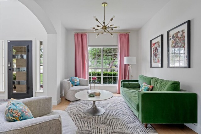 102 Hurst Creek Rd, Lakeway, TX 78734 - living area with a chandelier, arched walkways, and wood finished floors