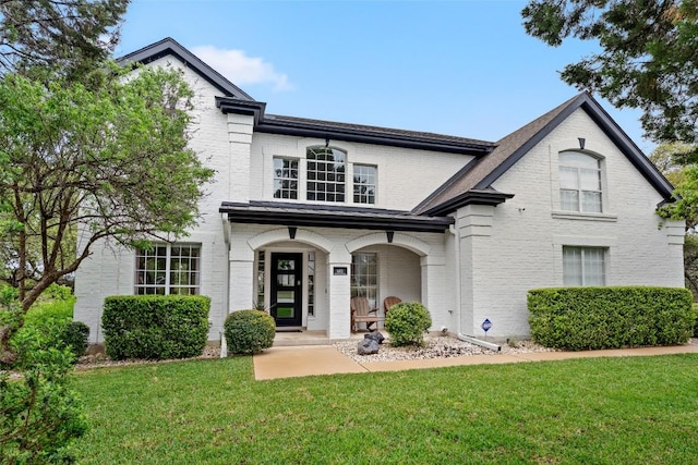 102 Hurst Creek Rd, Lakeway, TX 78734 - view of front of house with brick siding, a front yard, and a porch