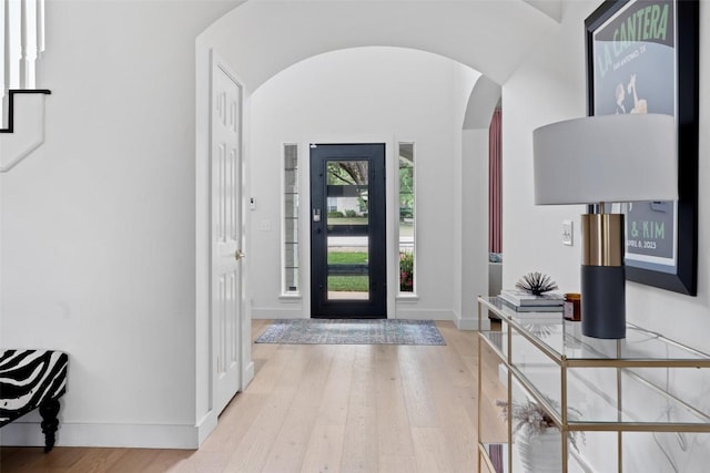 102 Hurst Creek Rd, Lakeway, TX 78734 - entrance foyer with arched walkways, light wood-style flooring, and baseboards