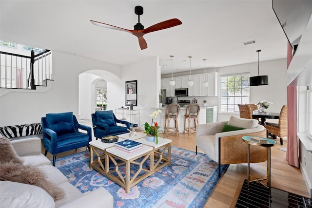 102 Hurst Creek Rd, Lakeway, TX 78734 - living area with ceiling fan, wood finished floors, and arched walkways
