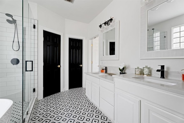 102 Hurst Creek Rd, Lakeway, TX 78734 - full bathroom featuring a stall shower, double vanity, and a freestanding bath