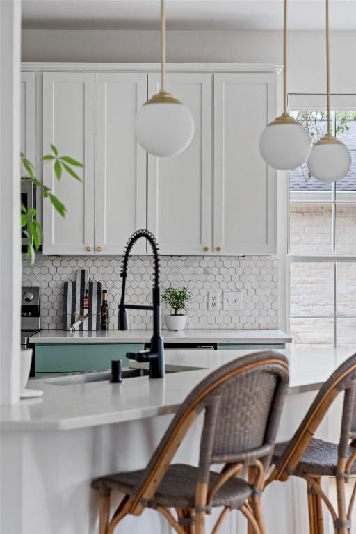 102 Hurst Creek Rd, Lakeway, TX 78734 - kitchen featuring decorative backsplash and white cabinetry