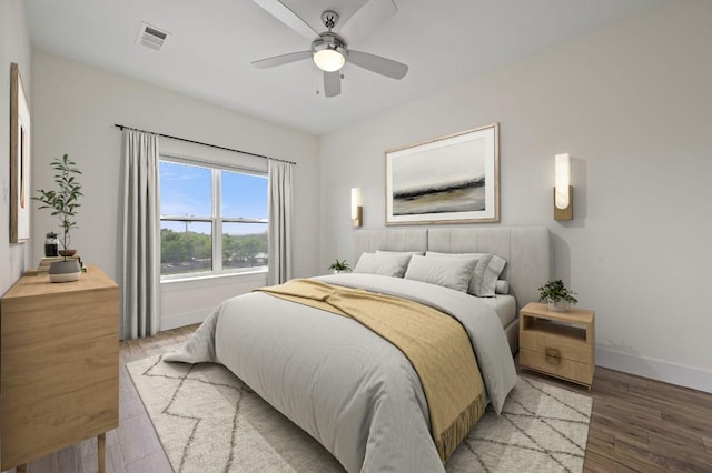 6444 Burnet Rd Unit 310, Austin, TX 78757 - bedroom featuring baseboards, visible vents, light wood-type flooring, and ceiling fan