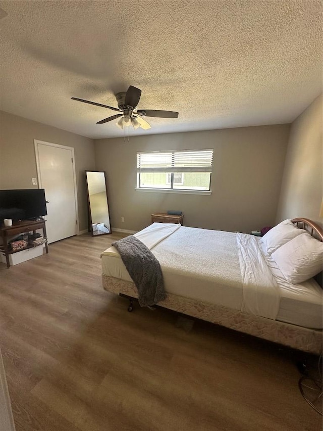 513 Purple Sage Dr, Round Rock, TX 78681 - bedroom with a textured ceiling, ceiling fan, and wood finished floors
