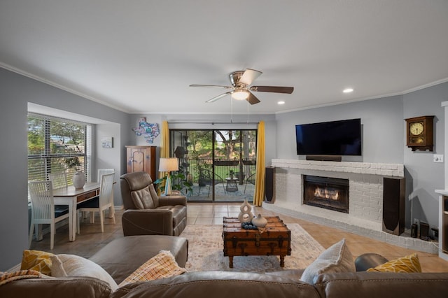 tiled living room with ornamental molding, a fireplace, ceiling fan, and plenty of natural light