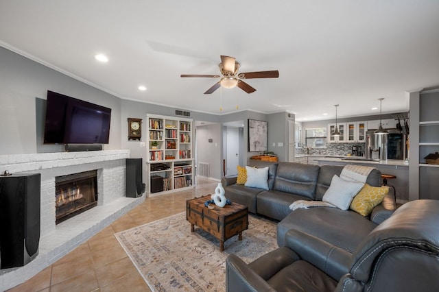 1135 Barton Hills Dr Unit 136, Austin, TX 78704 - living room featuring light tile patterned floors, ceiling fan, recessed lighting, ornamental molding, and a brick fireplace
