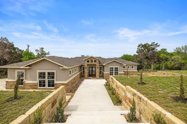 25101 Fawn Dr, Leander, TX 78641 - view of front of home featuring stucco siding, stone siding, driveway, and french doors