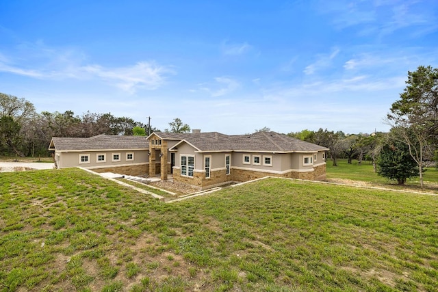 25101 Fawn Dr, Leander, TX 78641 - rear view of house featuring stone siding, a lawn, a chimney, and stucco siding