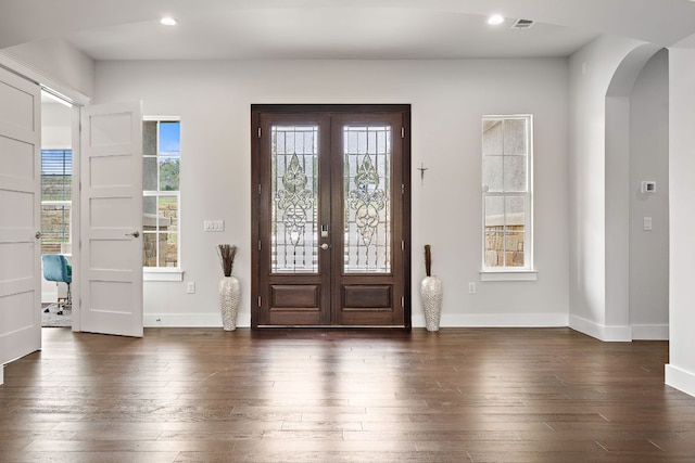 25101 Fawn Dr, Leander, TX 78641 - entrance foyer featuring arched walkways, french doors, dark wood-style flooring, healthy amount of natural light, and recessed lighting