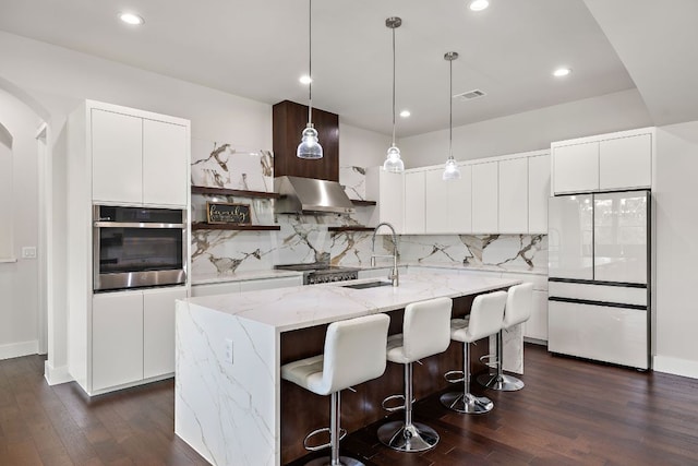 25101 Fawn Dr, Leander, TX 78641 - kitchen with stainless steel oven, a sink, freestanding refrigerator, ventilation hood, and dark wood-style flooring