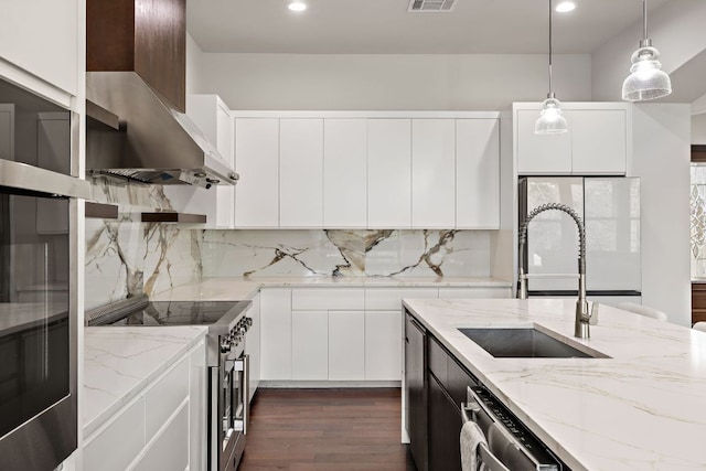 25101 Fawn Dr, Leander, TX 78641 - kitchen featuring appliances with stainless steel finishes, a sink, dark wood finished floors, decorative light fixtures, and recessed lighting