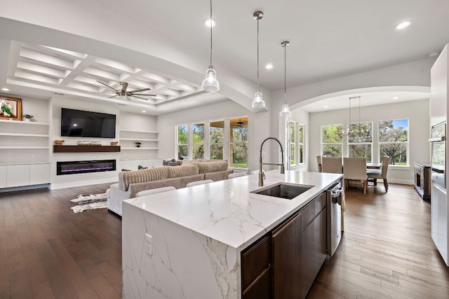 25101 Fawn Dr, Leander, TX 78641 - kitchen with a sink, recessed lighting, ceiling fan, arched walkways, and dark wood-type flooring
