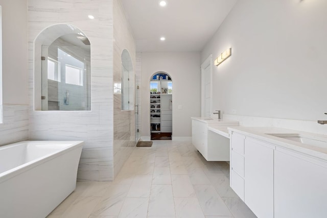 25101 Fawn Dr, Leander, TX 78641 - full bath with vanity, a freestanding bath, a walk in shower, recessed lighting, and marble finish flooring