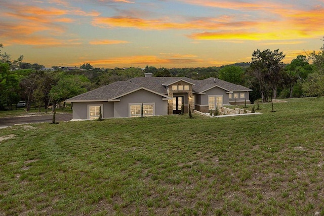 25101 Fawn Dr, Leander, TX 78641 - view of front of house with stucco siding, a lawn, and a chimney