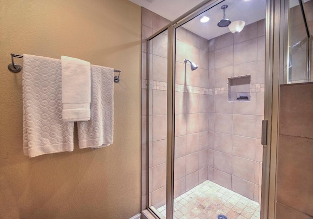 full bath with a shower stall