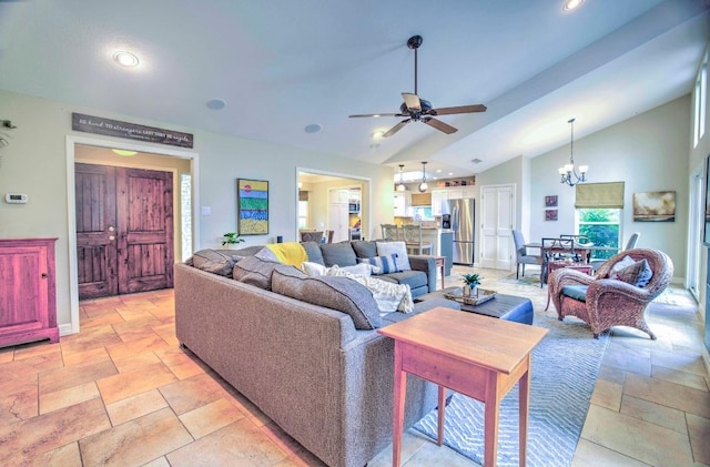 living room with baseboards, stone tile flooring, recessed lighting, and ceiling fan with notable chandelier