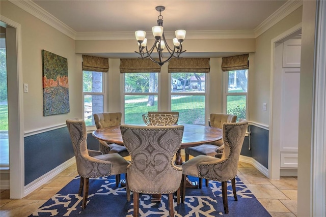 dining area featuring baseboards, crown molding, and a notable chandelier