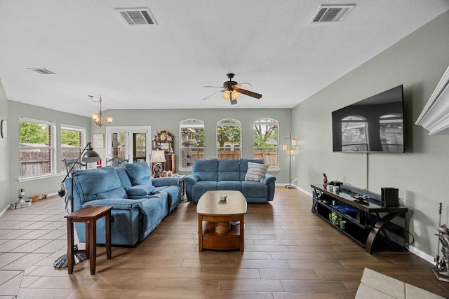 2312 Mcgregor Ln, Cedar Park, TX 78613 - living area featuring baseboards, ceiling fan, wood finish floors, a chandelier, and a textured ceiling