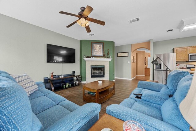 2312 Mcgregor Ln, Cedar Park, TX 78613 - living room featuring arched walkways, wood finished floors, a ceiling fan, and baseboards