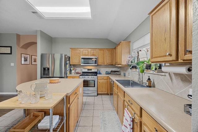 2312 Mcgregor Ln, Cedar Park, TX 78613 - kitchen with appliances with stainless steel finishes, a sink, light countertops, arched walkways, and backsplash