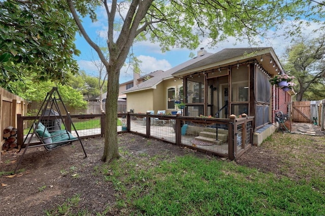 2312 Mcgregor Ln, Cedar Park, TX 78613 - back of property with a sunroom, a fenced backyard, a chimney, and a gate