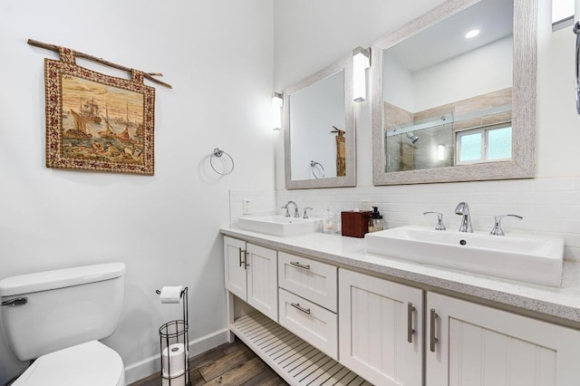 200 Oak Grove Dr, Dripping Springs, TX 78620 - full bathroom featuring a shower stall, tasteful backsplash, a sink, and toilet