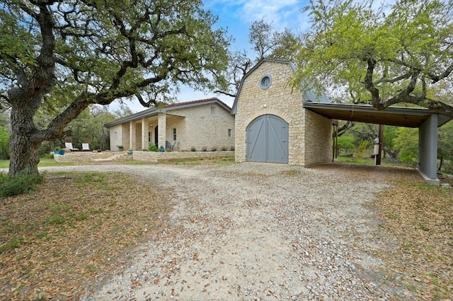 200 Oak Grove Dr, Dripping Springs, TX 78620 - view of front of property with an attached carport, stone siding, and dirt driveway