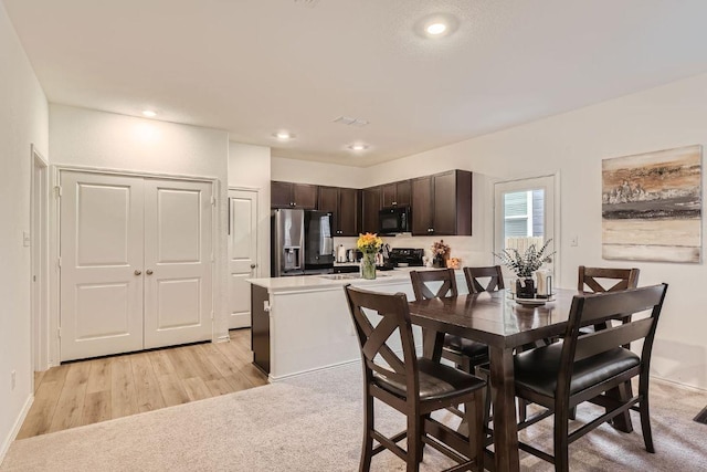 344 The Bad Way, Jarrell, TX 76537 - dining room with recessed lighting, light wood finished floors, and light carpet
