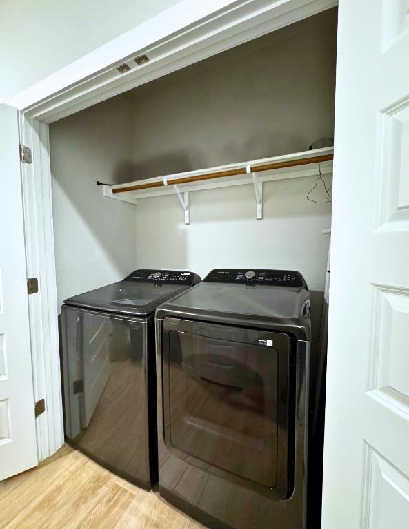 131 Harvest Ridge Blvd, Elgin, TX 78621 - laundry area featuring separate washer and dryer and light wood finished floors