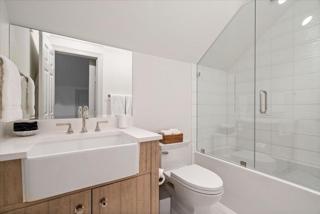 24729 Travis Lakeside Cv, Spicewood, TX 78669 - bathroom with toilet, vanity, lofted ceiling, and shower / bath combination with glass door
