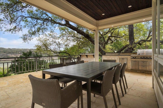24729 Travis Lakeside Cv, Spicewood, TX 78669 - view of patio / terrace featuring exterior kitchen and outdoor dining space