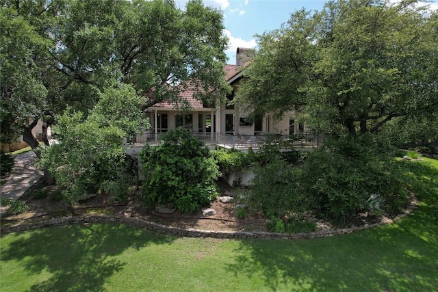 24729 Travis Lakeside Cv, Spicewood, TX 78669 - back of property featuring a tiled roof, a lawn, and stucco siding