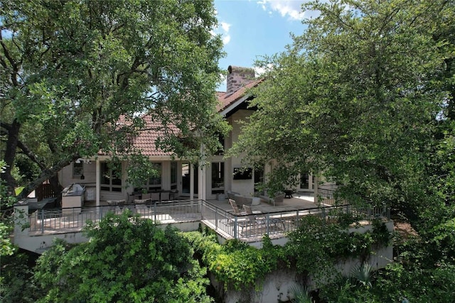 24729 Travis Lakeside Cv, Spicewood, TX 78669 - back of property with a tiled roof and stucco siding