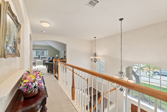 2907 Briona Wood Ln, Cedar Park, TX 78613 - hallway with a chandelier, light colored carpet, an upstairs landing, and arched walkways